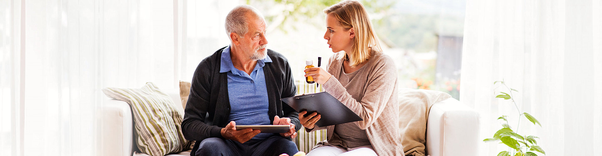 caregiver and senior man having a conversation
