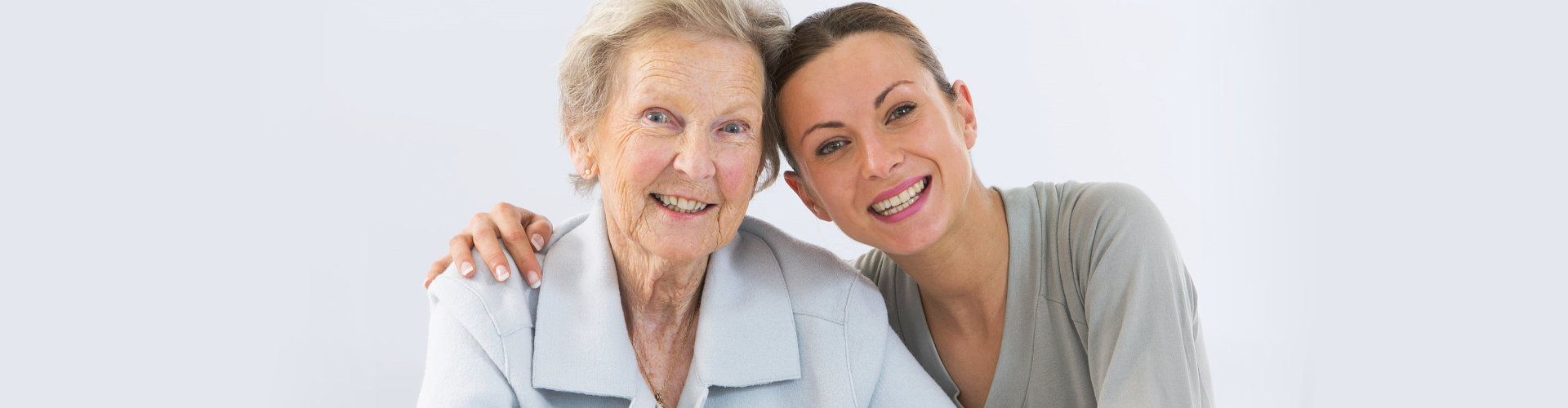 caregiver and senior woman are smiling